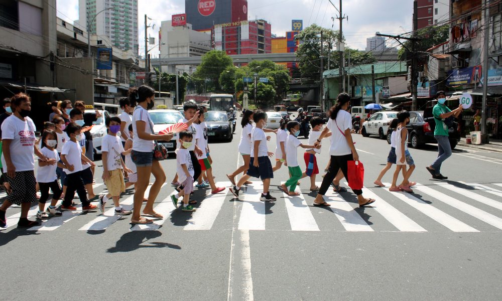 Parents and children crossing the pedestrian lane