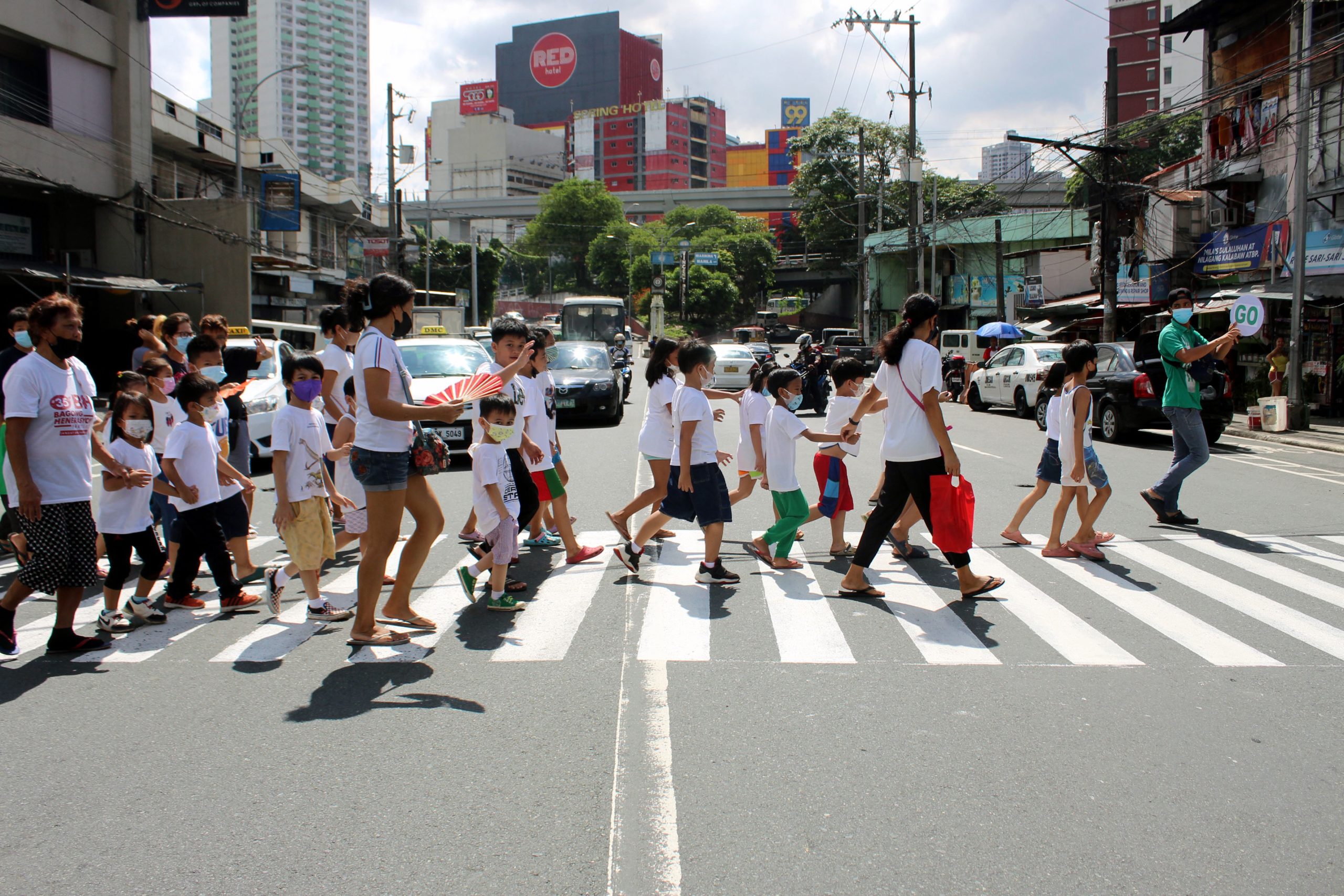 Parents and children crossing the pedestrian lane