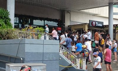 Queue at automated teller machines outside a mall
