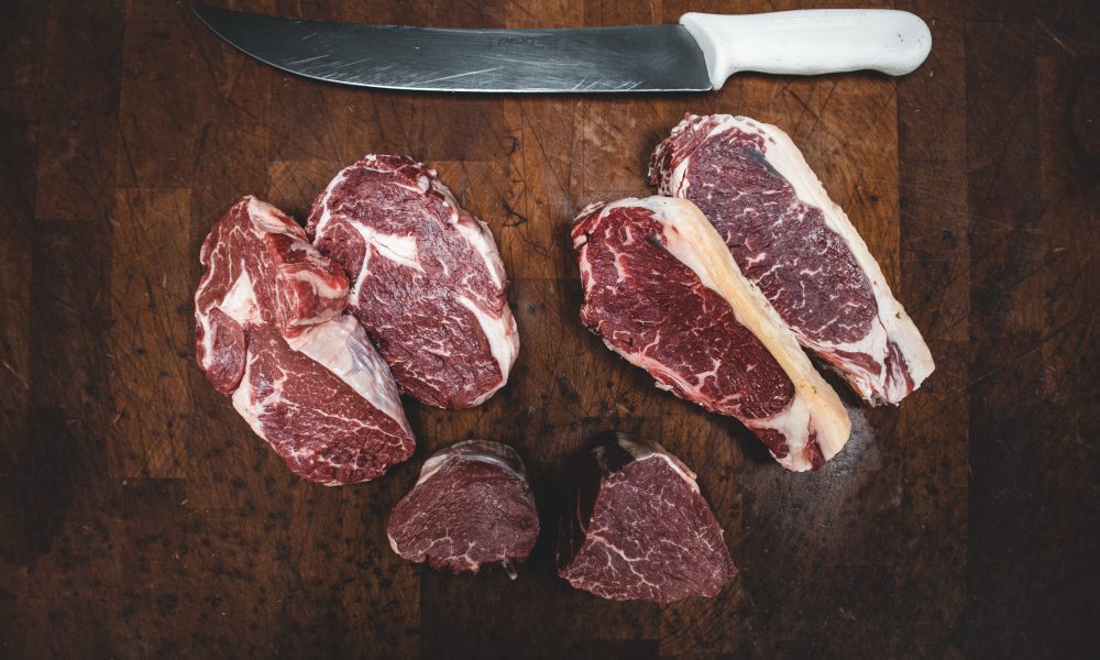 Sliced meat beside a knife