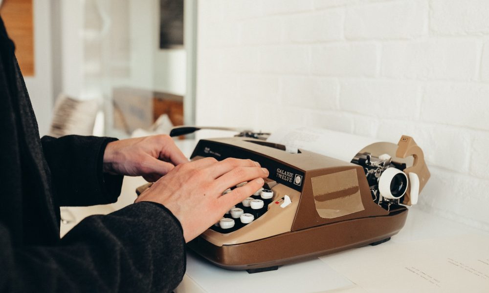 hands typing on typewriter