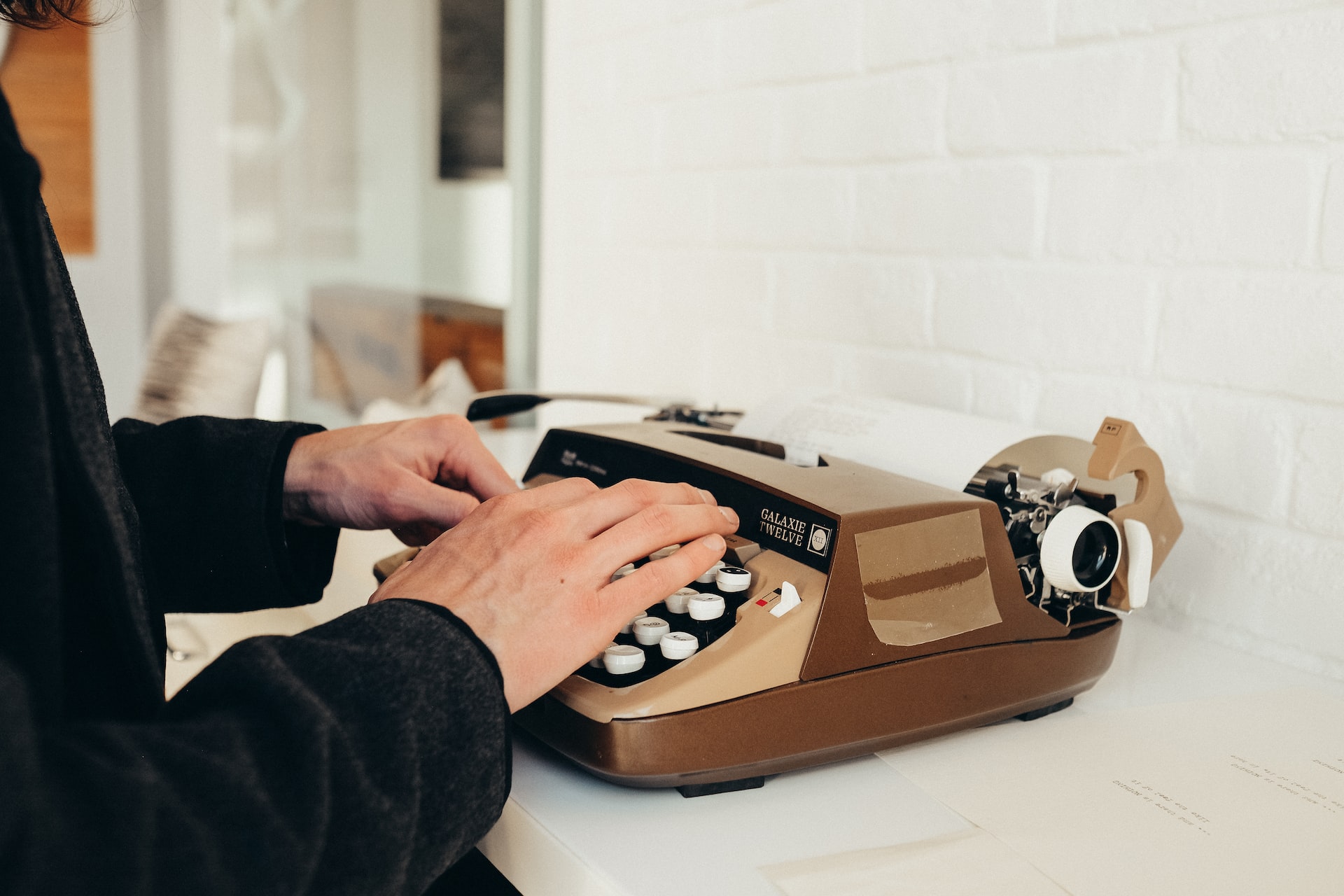 hands typing on typewriter