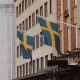 two sweden flag raised on window building