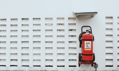 Red Fire Extinguisher on White Wall