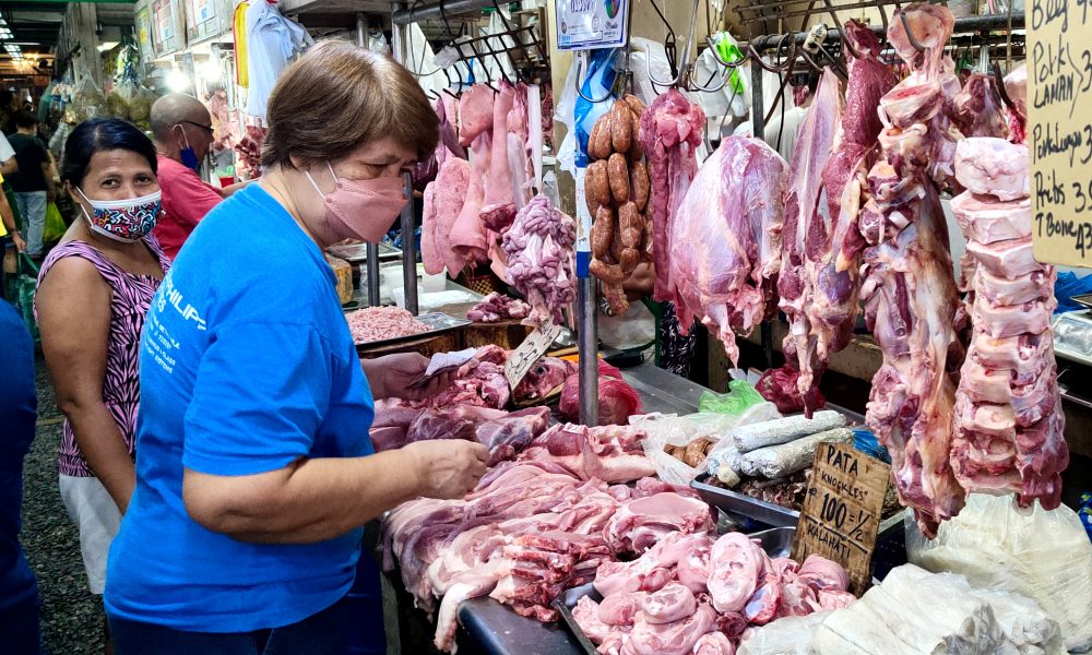 woman chooses from the different cuts of meat
