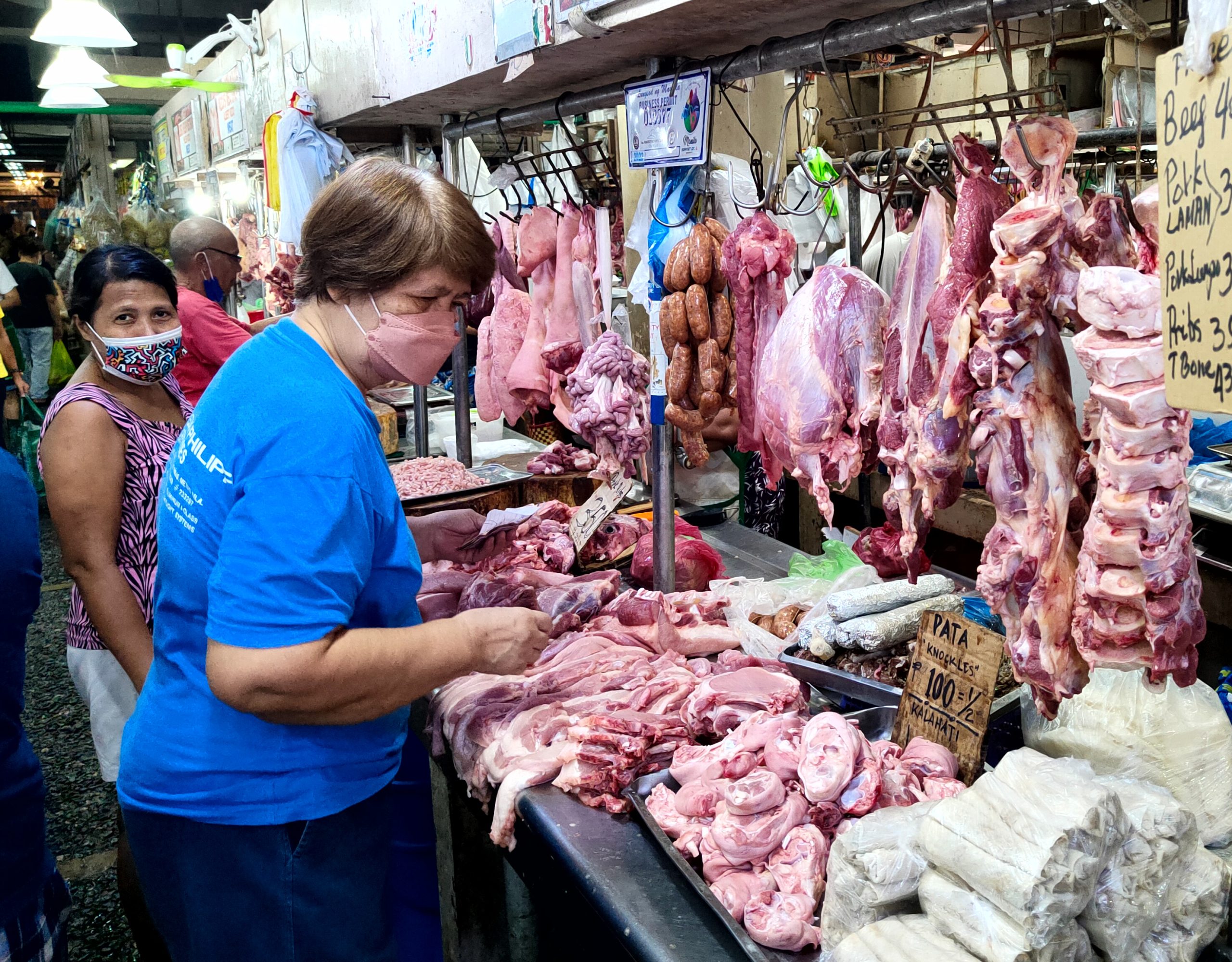woman chooses from the different cuts of meat