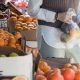 woman choosing citruses in a market