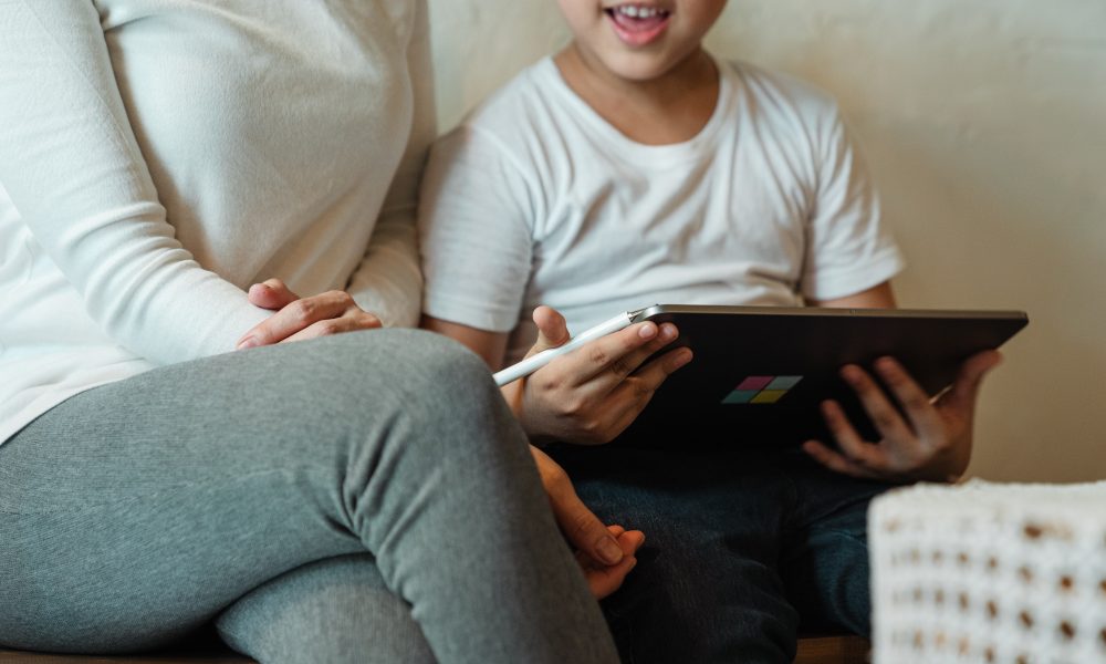 woman with son using tablet at home