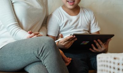 woman with son using tablet at home
