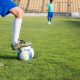 A Person Stepping on the Ball while Wearing Cleats