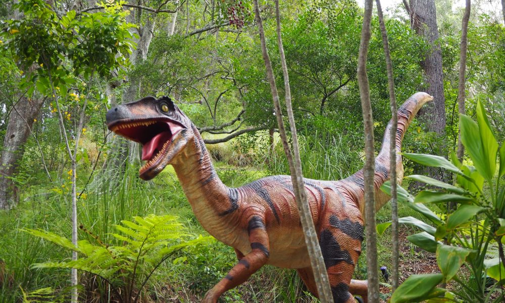 A dinosaur statue in the forest