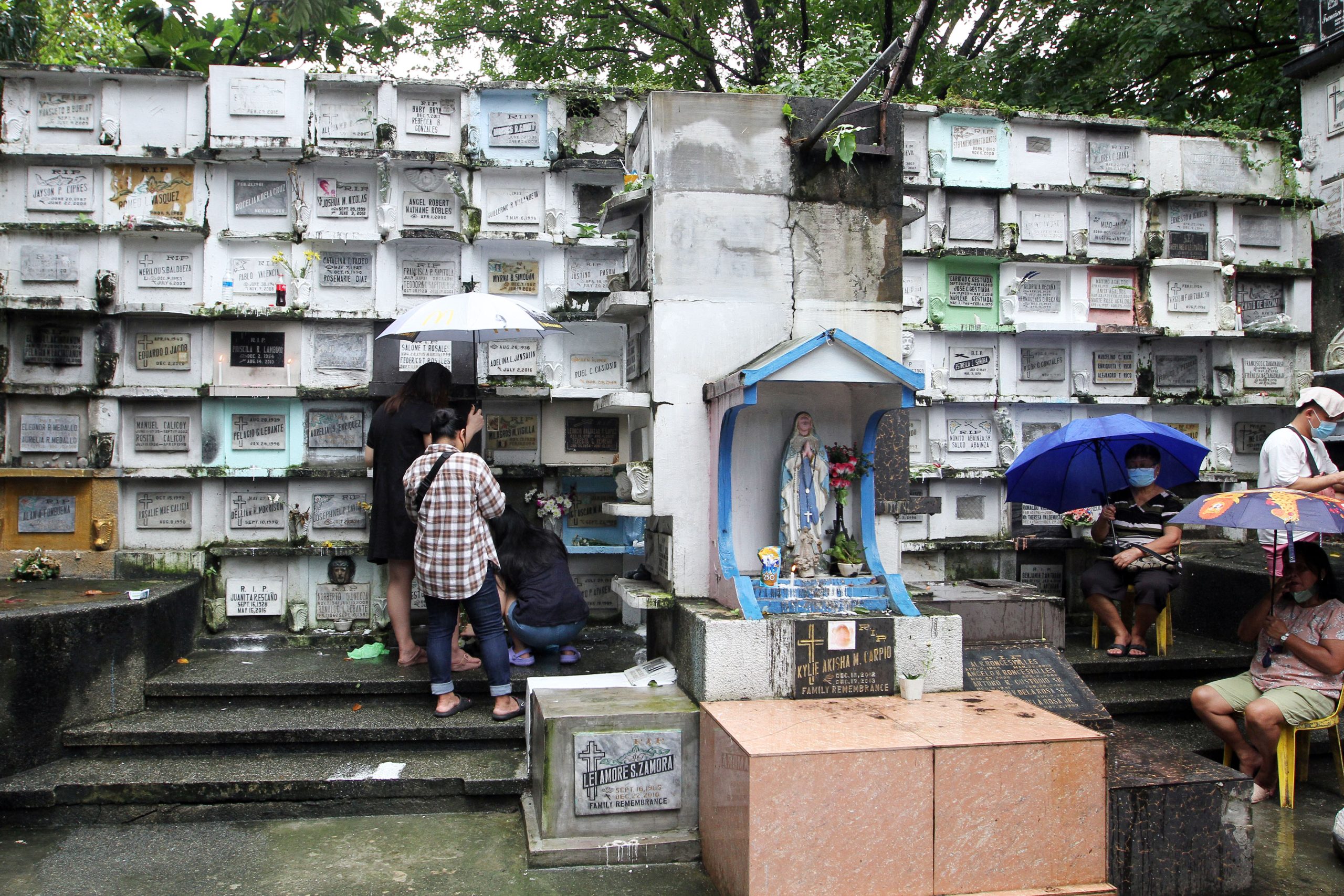 People visit the grave of their departed loved ones