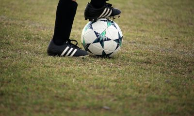 Person playing soccer on field