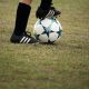 Person playing soccer on field