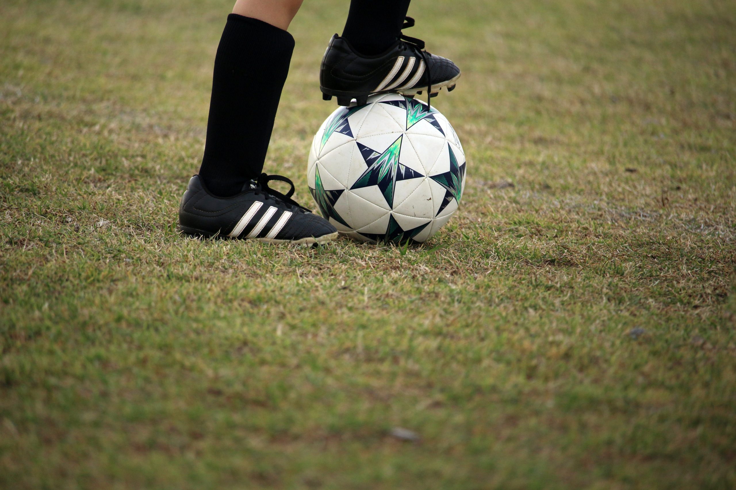 Person playing soccer on field