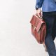 man with leather bag walking