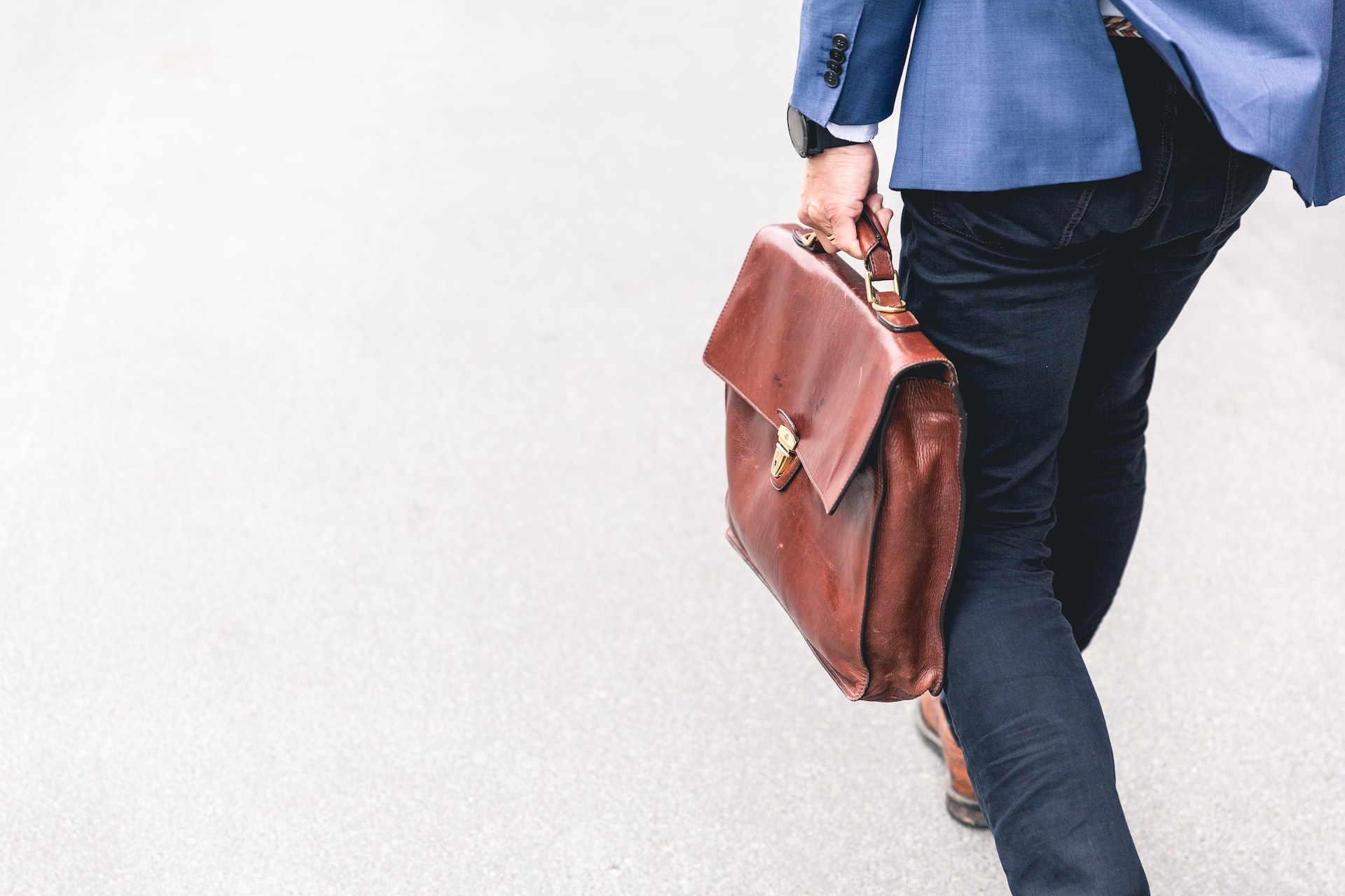 man with leather bag walking