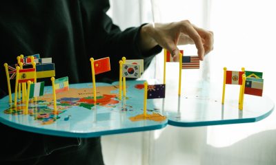 world map board with flags pinned