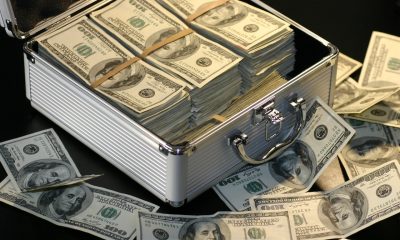 dollars inside briefcast and on table