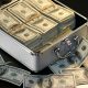 dollars inside briefcast and on table