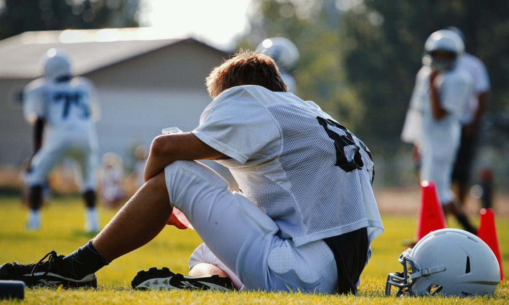 sitting football player