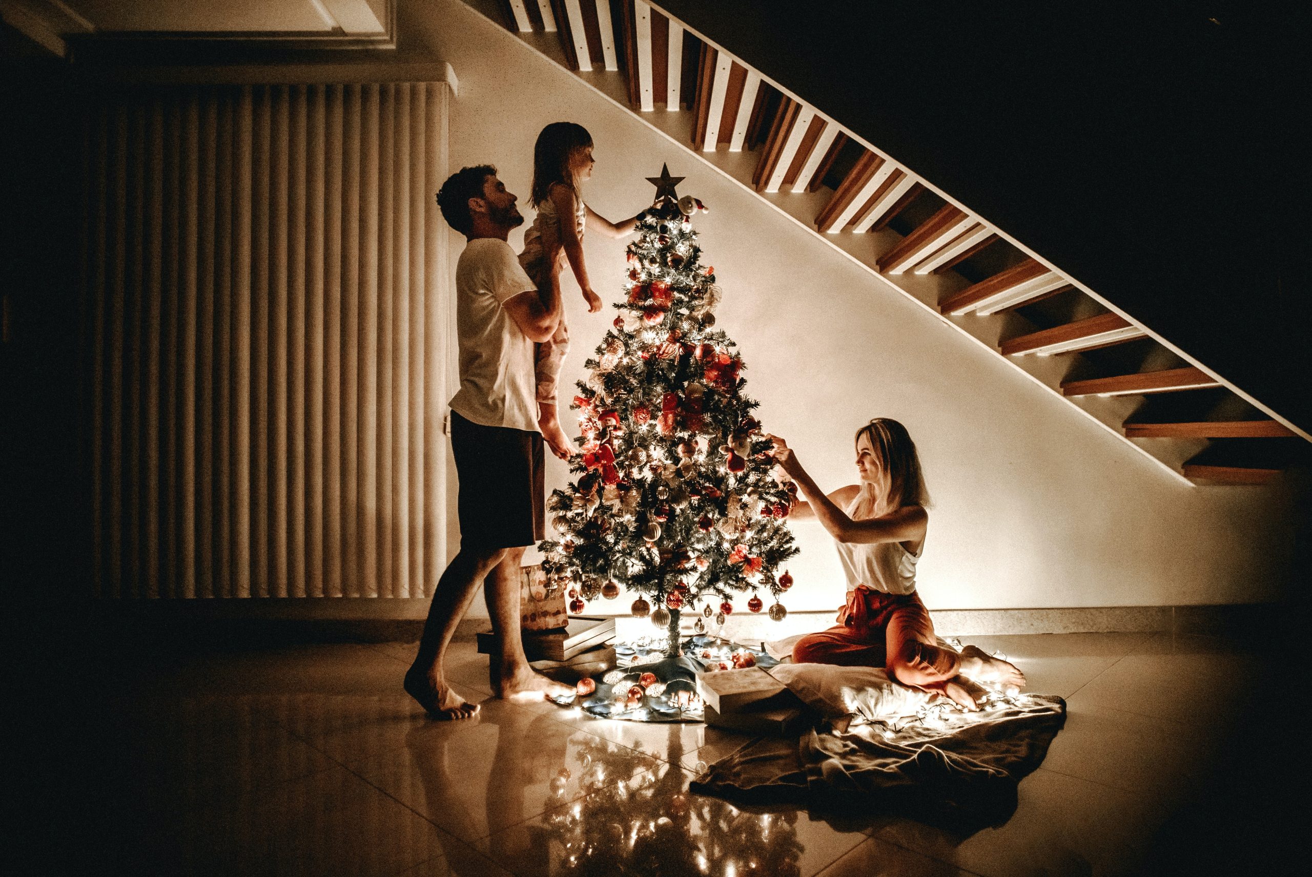 A family decorating their Christmas tree