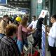 Airport security personnel check the documents of passengers