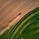 Farmers prepping the once lush green fields on a dusty Spring afternoon in Devon