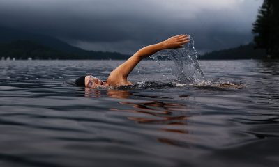 Man swimming on body of water