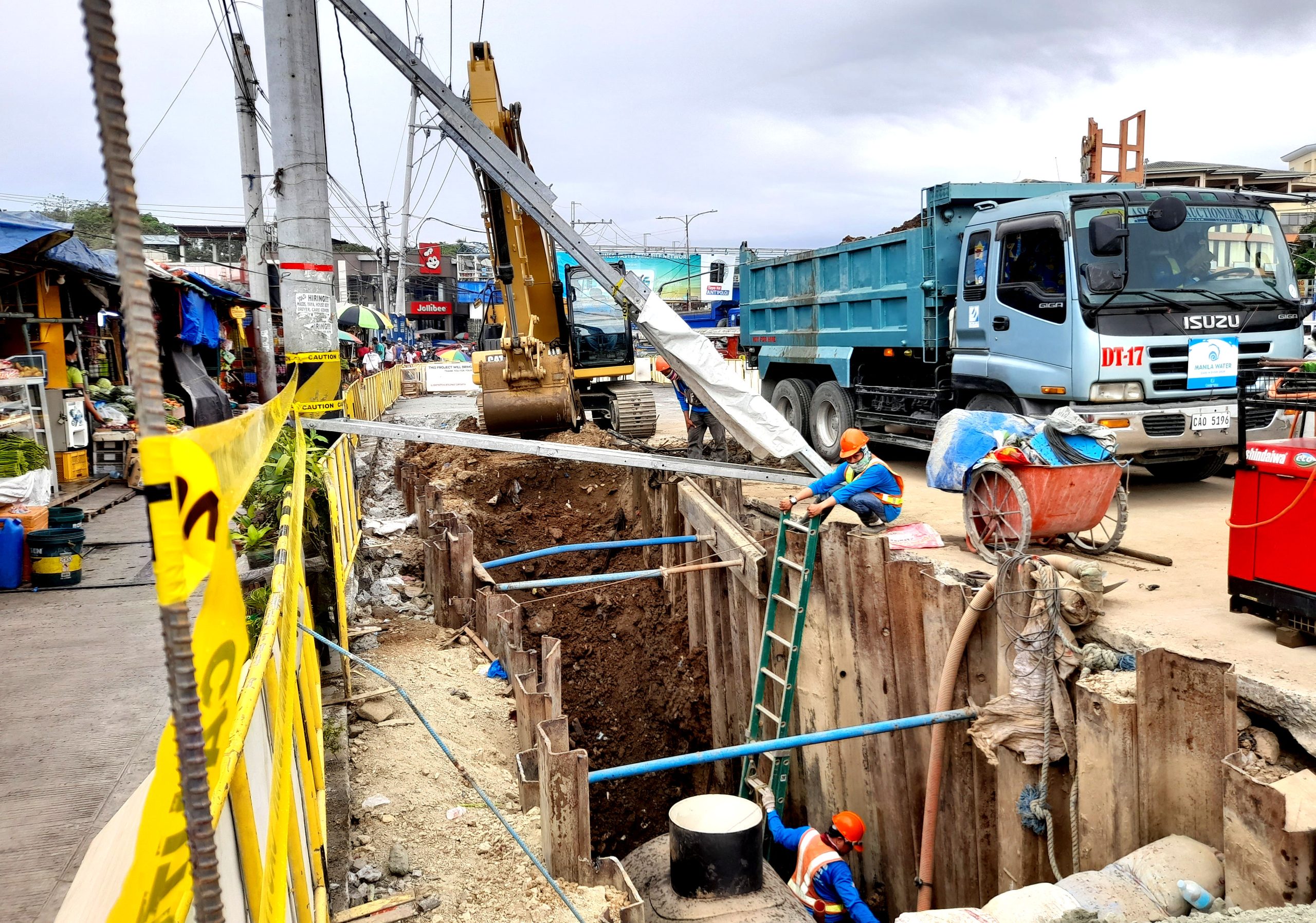 Workers of Manila Water Services Inc. repair leaks near Cogeo Market