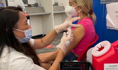 high school girl being vaccinated by girl nurse