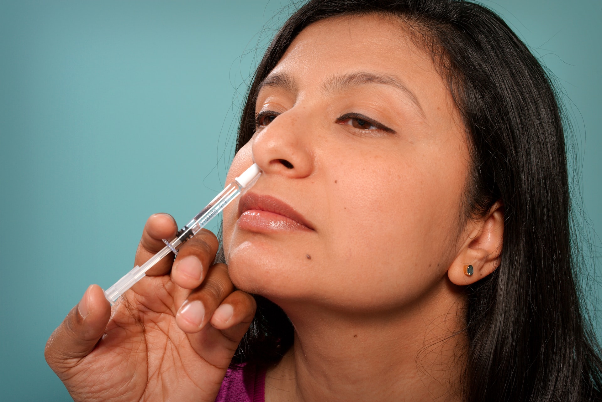 woman getting nasal vaccine