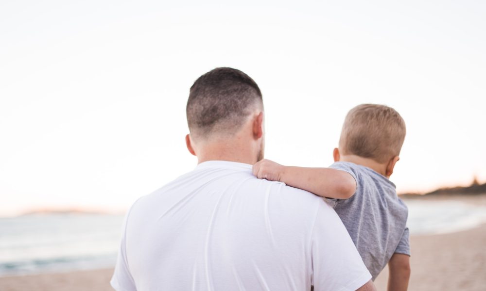 man carrying baby