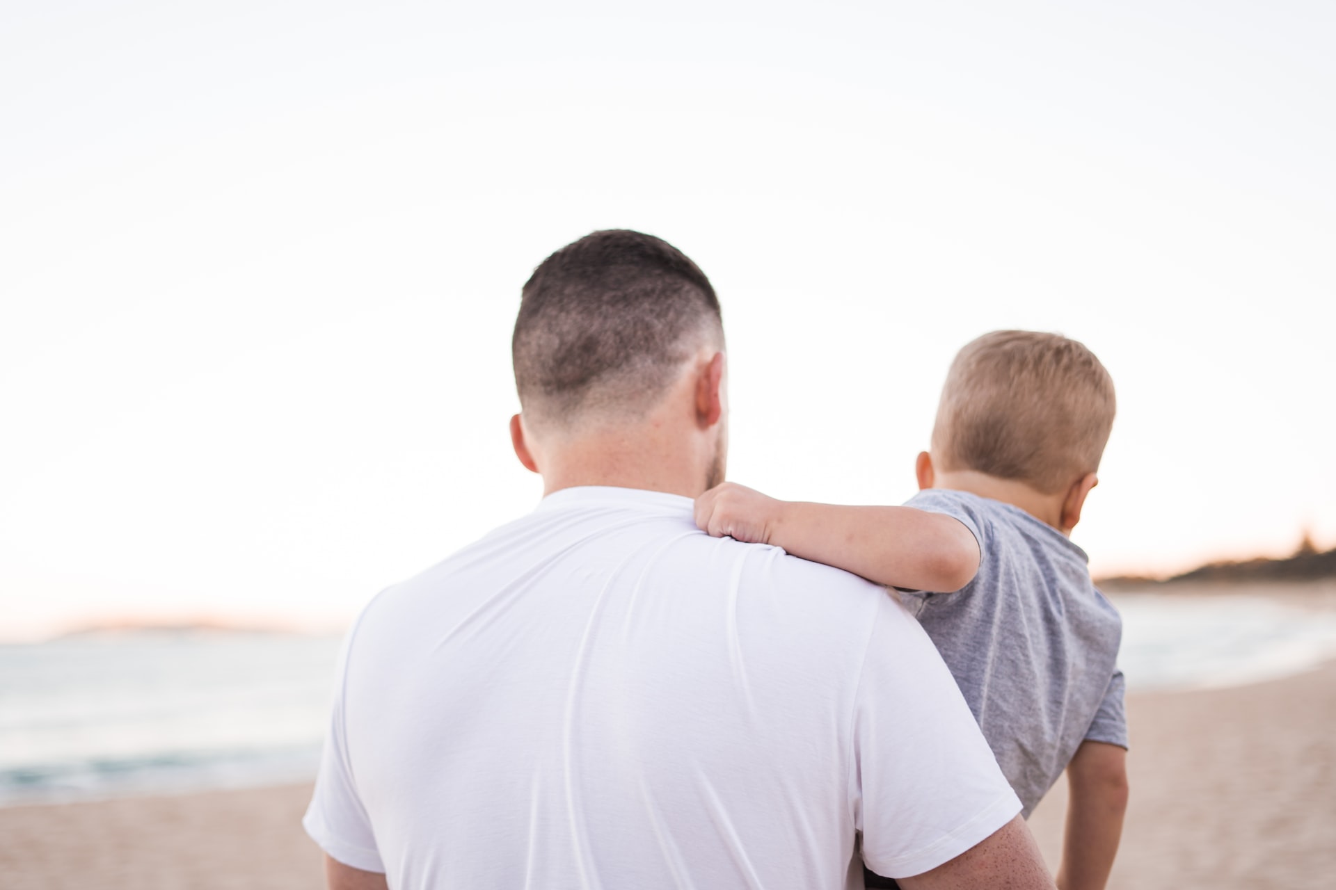 man carrying baby