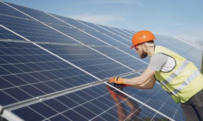 man fixing solar panel