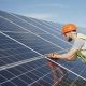 man fixing solar panel