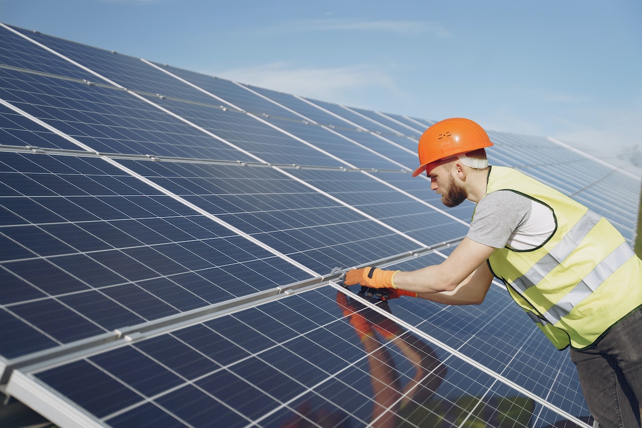 man fixing solar panel