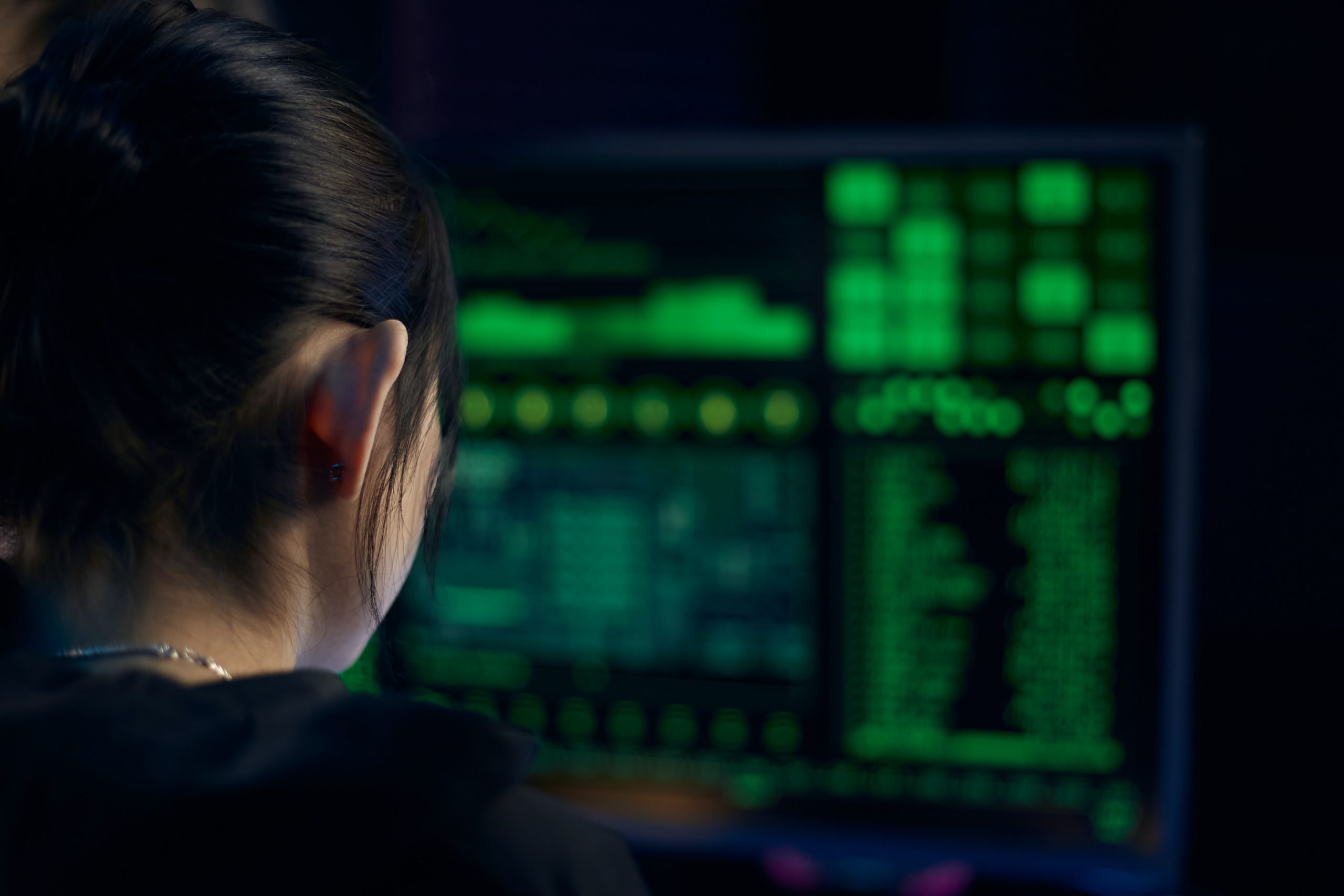 Woman in Black Shirt Looking at Neon