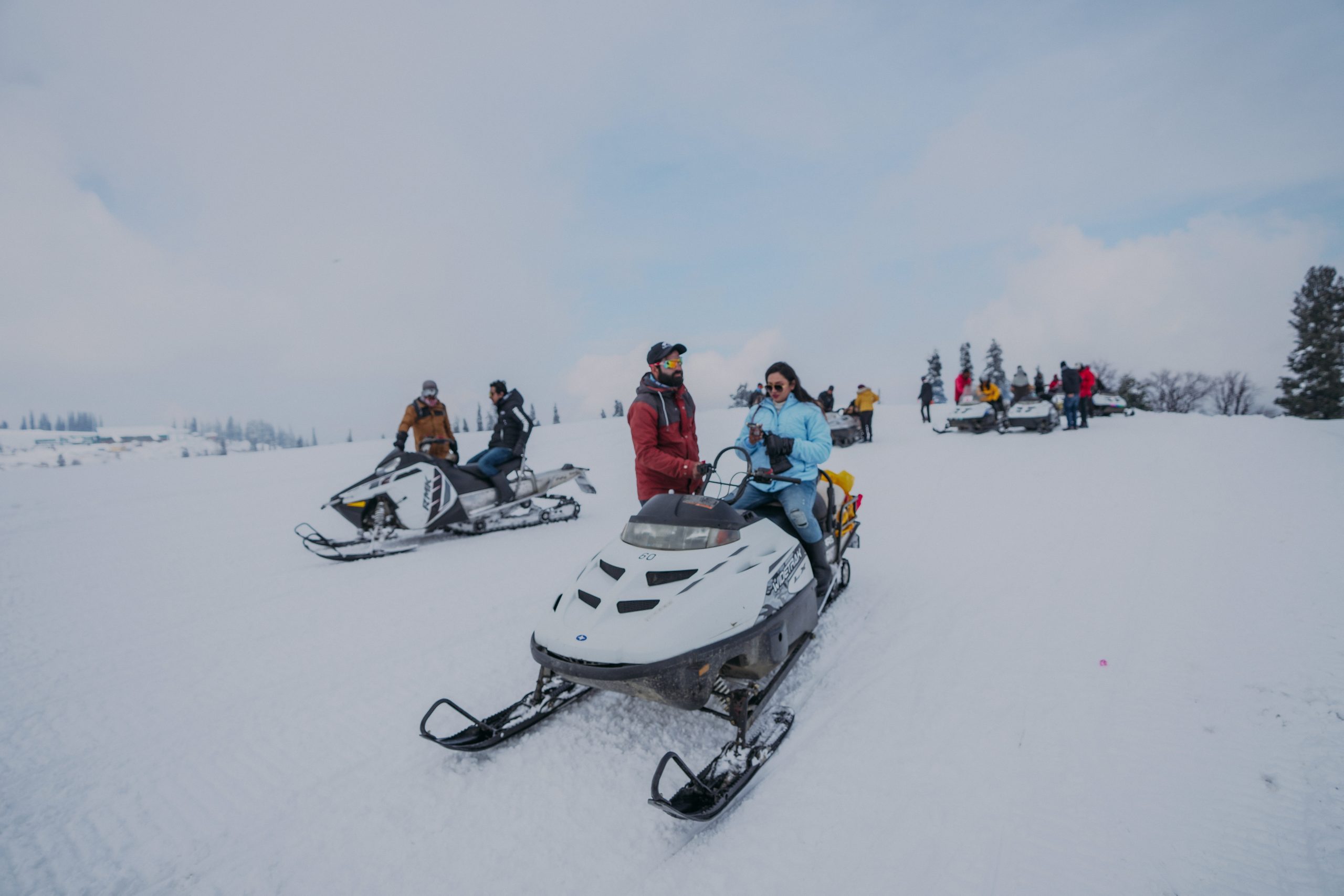 People Riding Snowmobiles