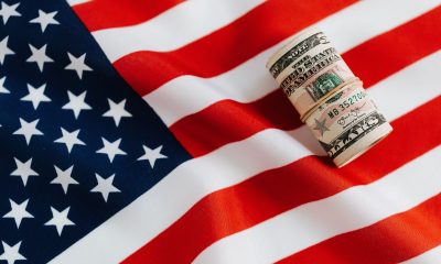 American flag with rolled dollar bills