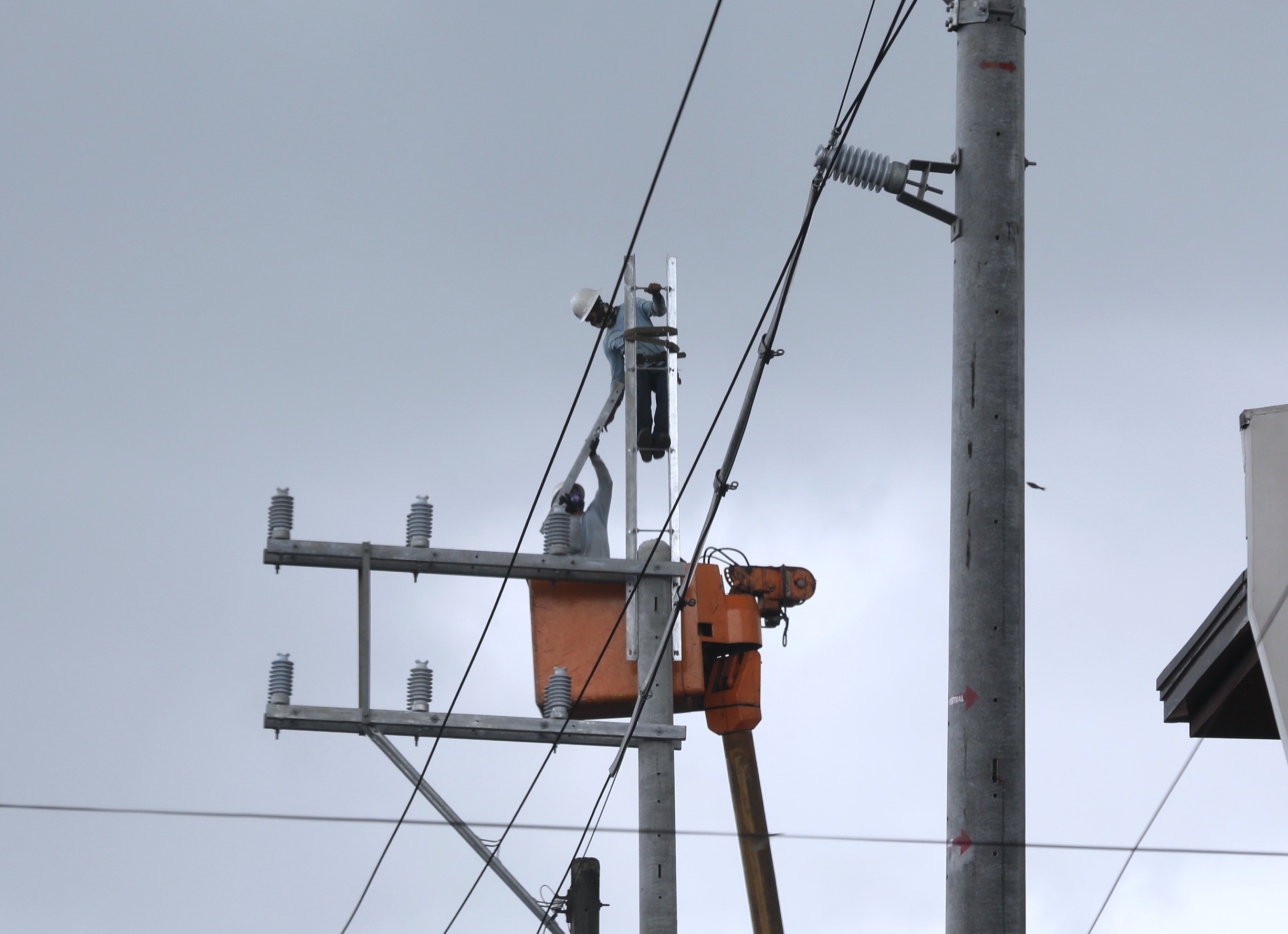 Electric power linemen transferring cables
