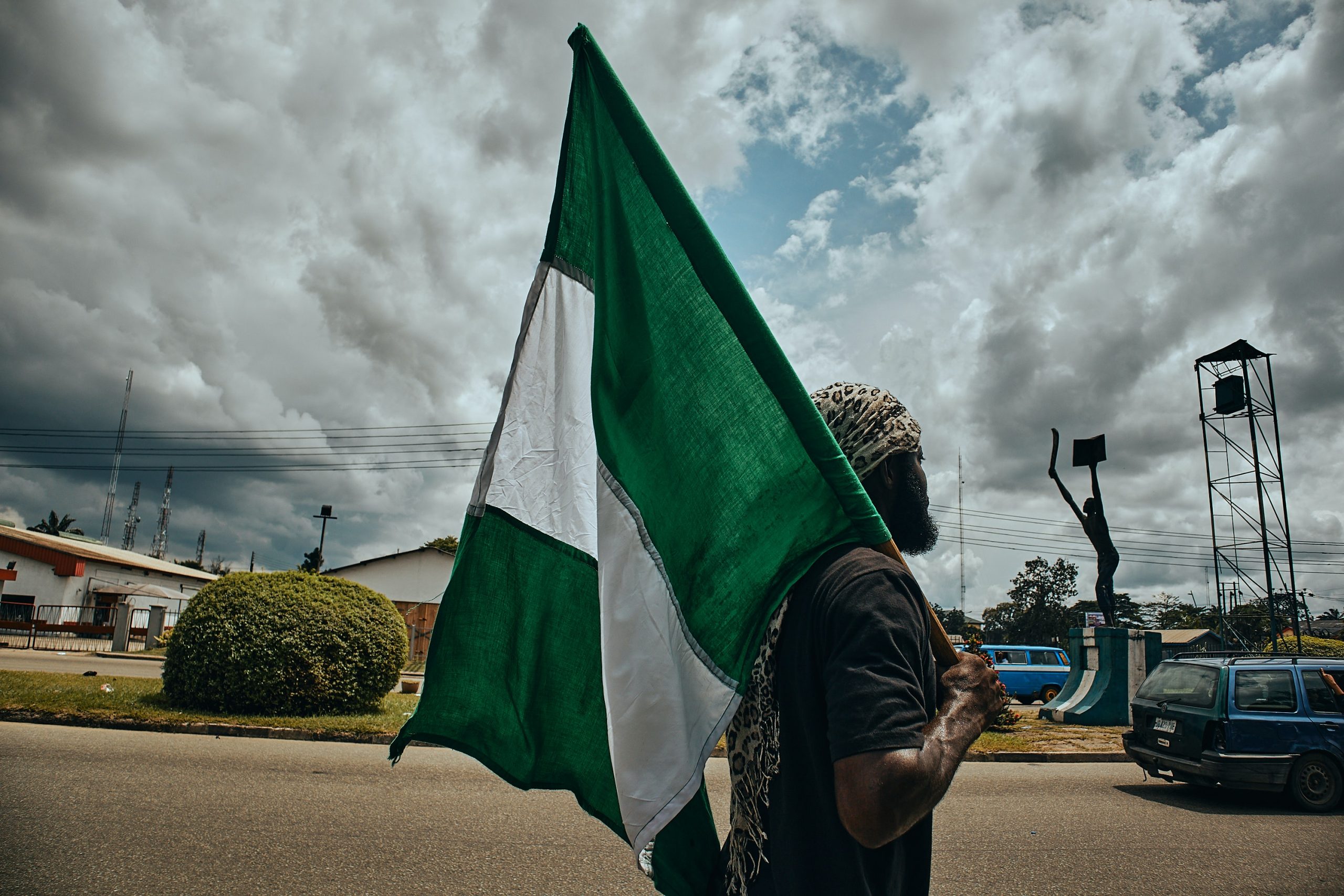 Man holding a Flag of Nigeria