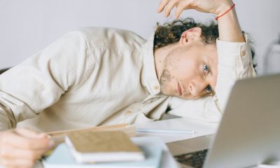 Overworked Employee lying in front of Laptop