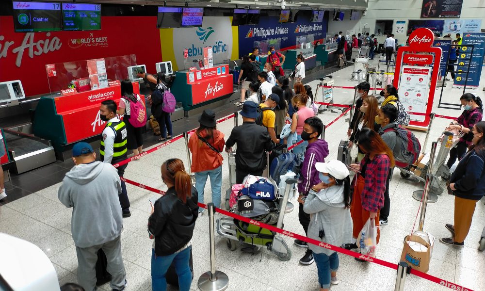 Passengers fall in line at the counter