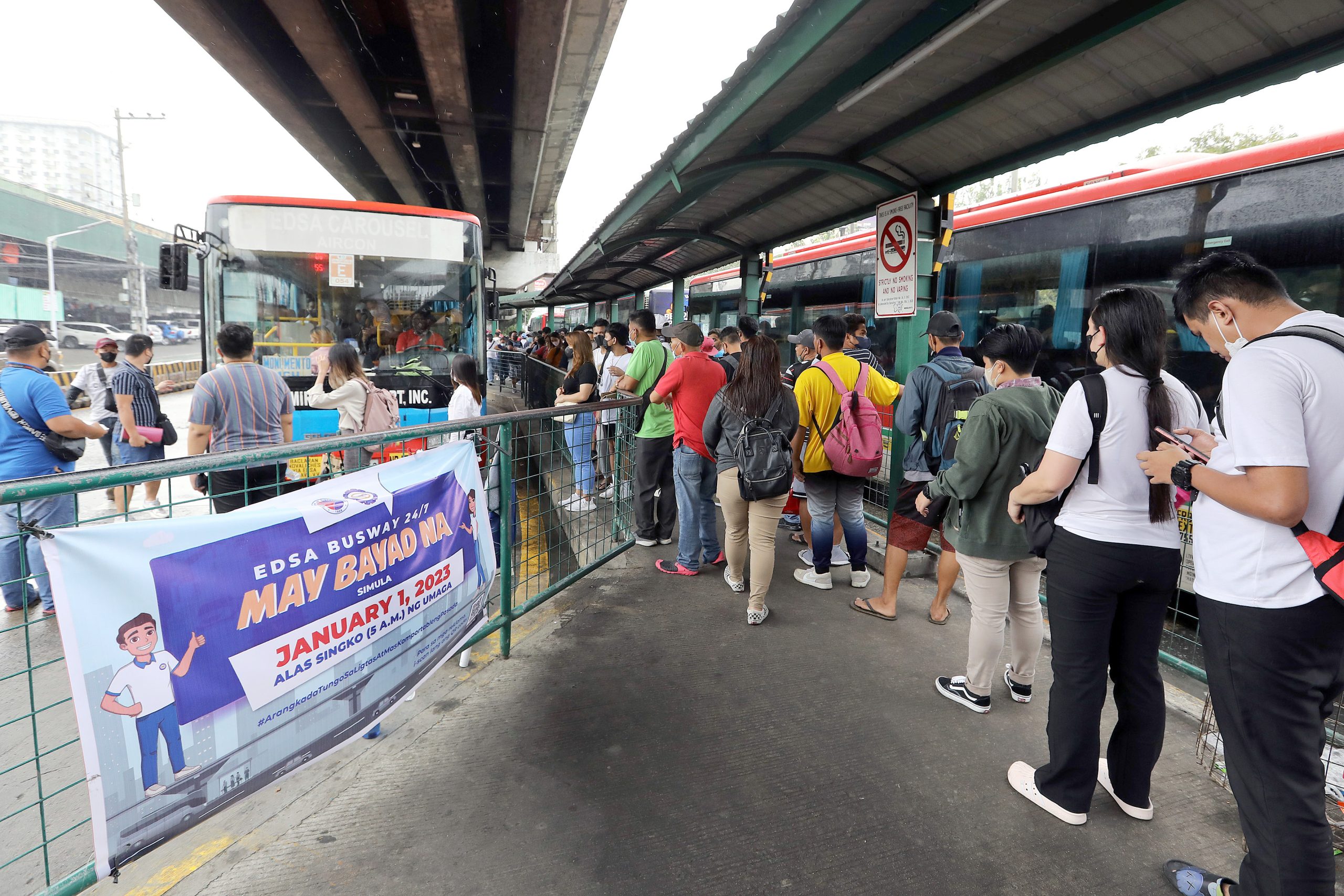 Passengers queue to get on board an Edsa Carousel bus