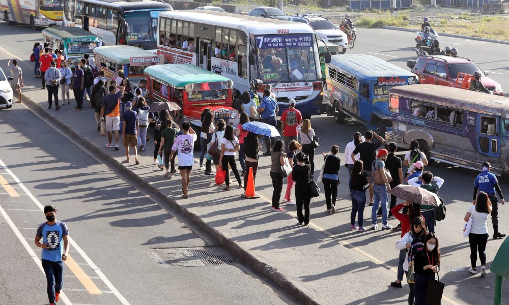 Passengers queue up for bus and jeepney rides