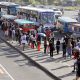 Passengers queue up for bus and jeepney rides