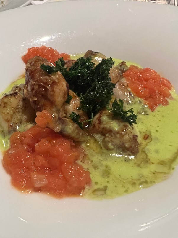 Frog legs with chive butter and tomato fondant.