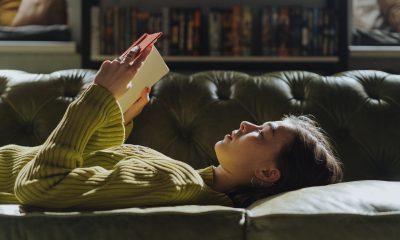 Woman in Yellow Long Sleeve Shirt Lying on Couch