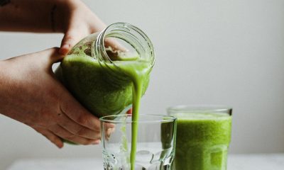 pouring green drink on glass